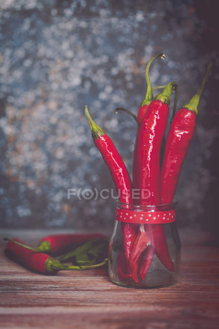 Spicy red chili peppers in a glass jar — Stock Photo