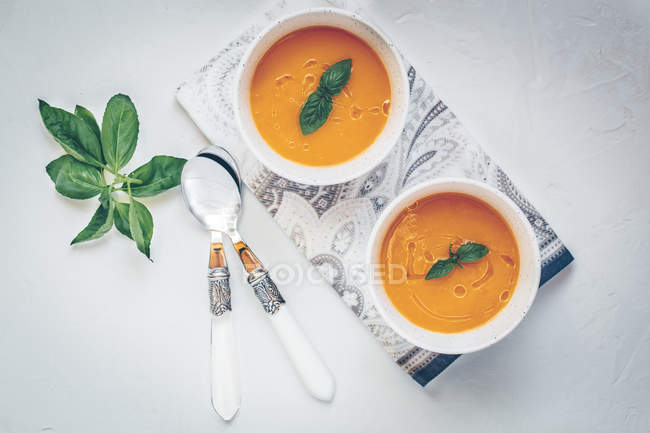 Two bowls of pumpkin soup, top view — Stock Photo