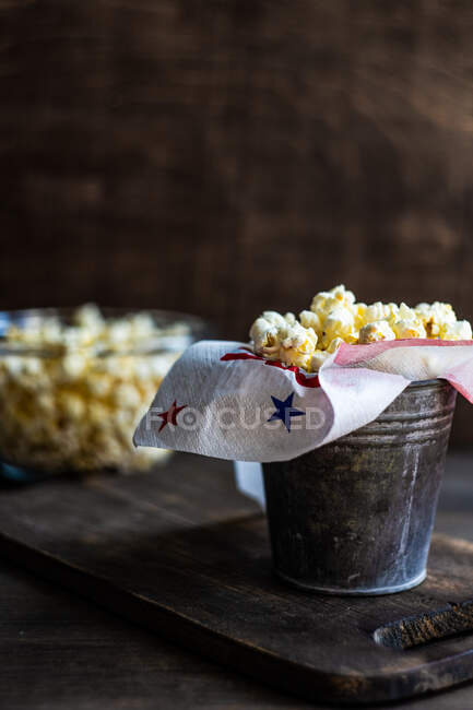 Popcorn in a glass jar on a wooden table — Stock Photo