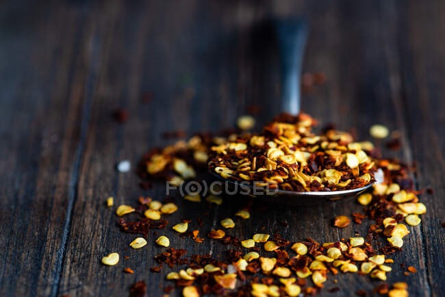 Dried organic spices in a wooden bowl on a dark background. — Stock Photo