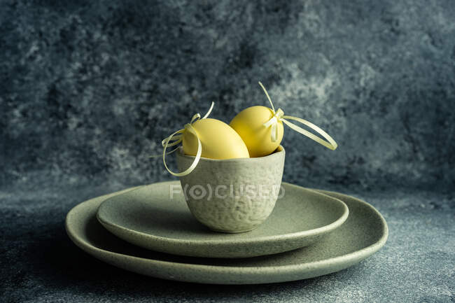 Two Easter eggs in a ceramic bowl arrangement — Stock Photo