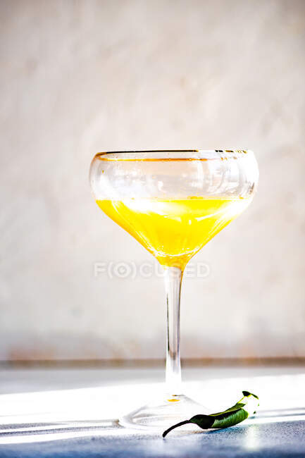 Glass of cocktail with lemon and mint on a wooden background — Stock Photo