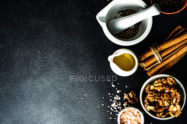 Spices and ingredients for cooking on black background — Stock Photo