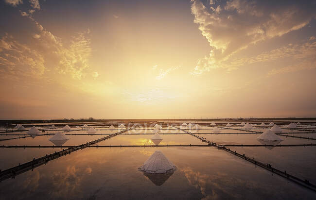 Salt piles in a salt flat at sunrise, Tainan, Taiwan — Stock Photo