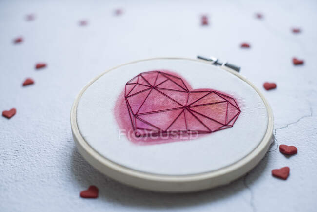 Close-up of an embroidery hoop with hearts — Stock Photo