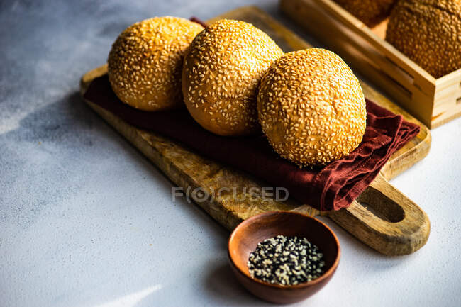 Homemade bread with sesame seeds on a white table — Stock Photo