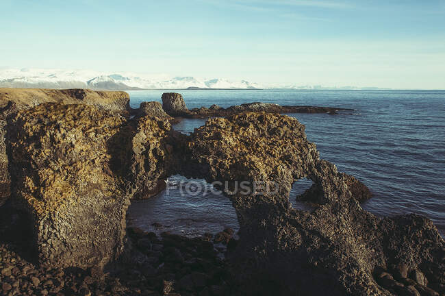 Arco natural en la playa rocosa, Islandia - foto de stock
