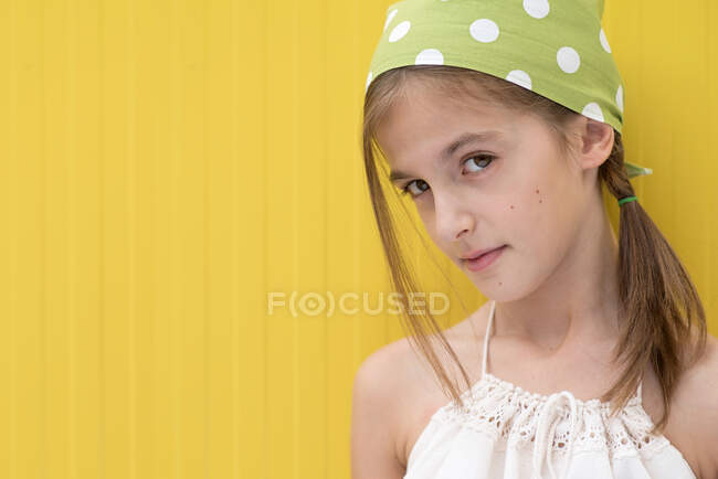 Portrait of a girl wearing a green polka dot headscarf — Stock Photo