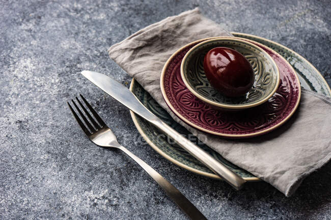 Posto pasquale apparecchiato su un tavolo con decorazione di uovo di Pasqua in ceramica — Foto stock