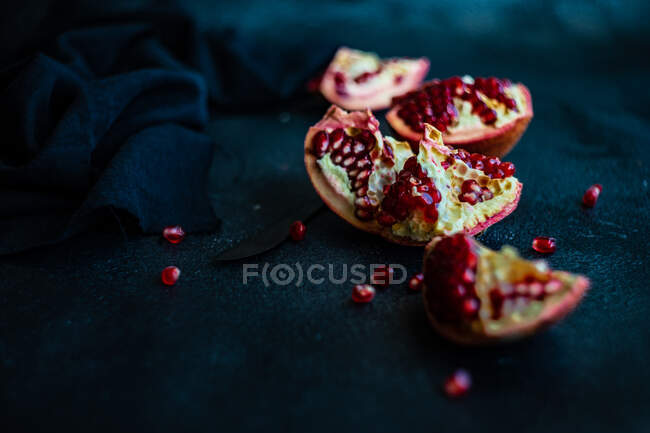 Organic pomegranate seeds on black background — Stock Photo