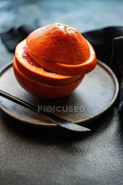 Slices of pink grapefruit on a stone plate — Stock Photo