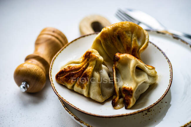 Traditional georgian dumplings called khinkali served on stone table — Stock Photo