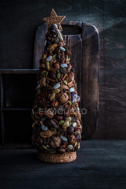 Adorno rústico del árbol de Navidad hecho de nueces frescas y especias - foto de stock