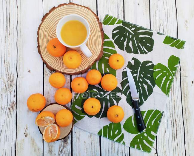 Arance, mandarini e succo d'arancia su un tavolo di legno — Foto stock