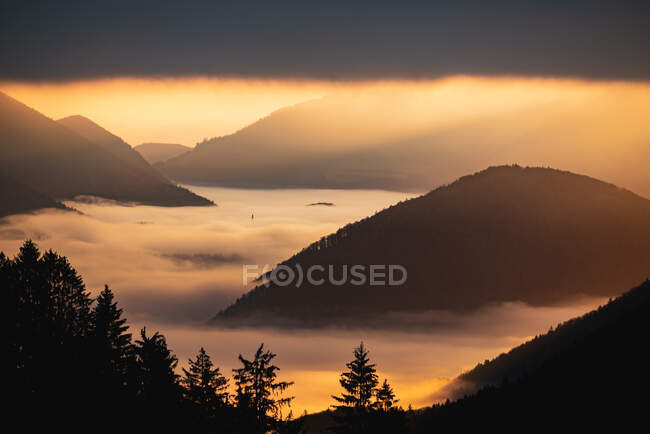 Mountain peaks through cloud carpet at sunrise, Salzburg, Austria — Stock Photo