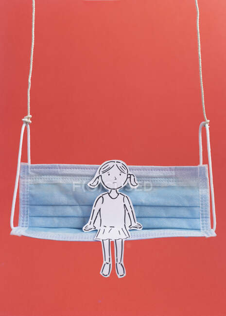 Conceptual girl sitting on a hanging swing — Stock Photo
