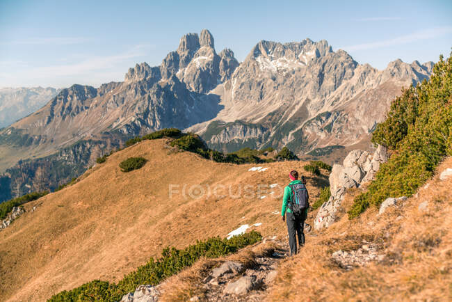 Woman hiking on footpath in alpine landscape in autumn, Filzmoos, Salzburg, Austria — Stock Photo