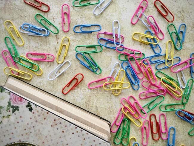Overhead view of notebook and paper clips — Stock Photo