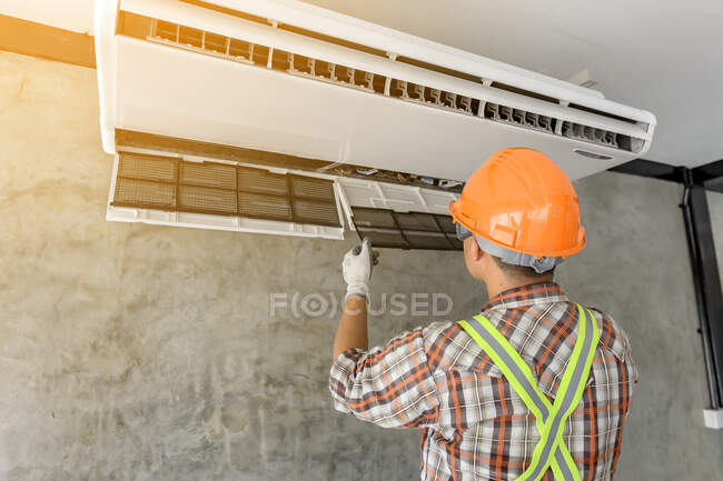 Electrician installing an air conditioning unit on a wall, Thailand — Stock Photo