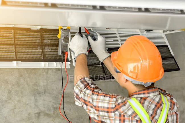 Electrician installing an air conditioning unit on a wall, Thailand — Stock Photo