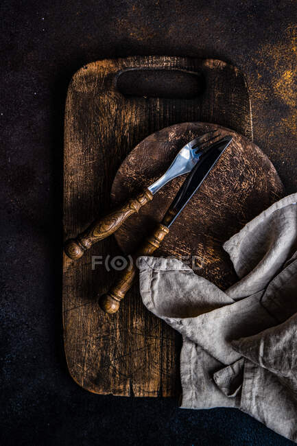 Rustic cutlery on wooden chopping boards — Stock Photo