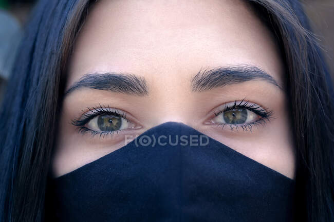 Portrait of a beautiful woman wearing a face mask — Stock Photo