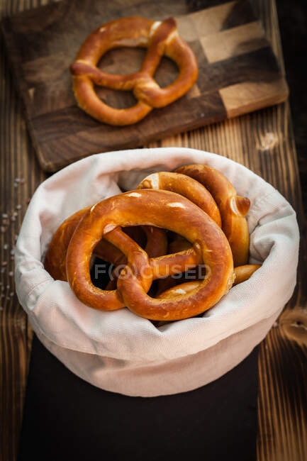 Freshly baked pretzels in a cotton bread serving bag — Stock Photo