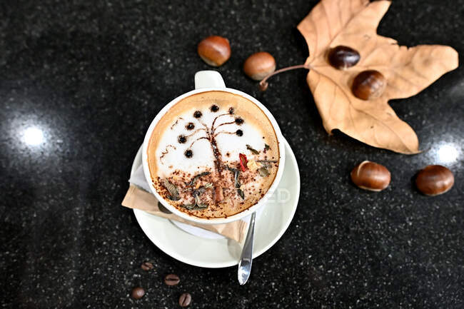 Cup of coffee with autumn landscape decoration — Stock Photo