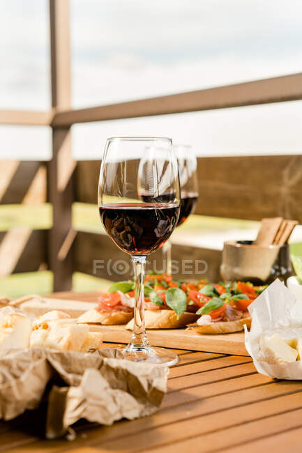 Antipasto and red wine on a table outdoors — Stock Photo