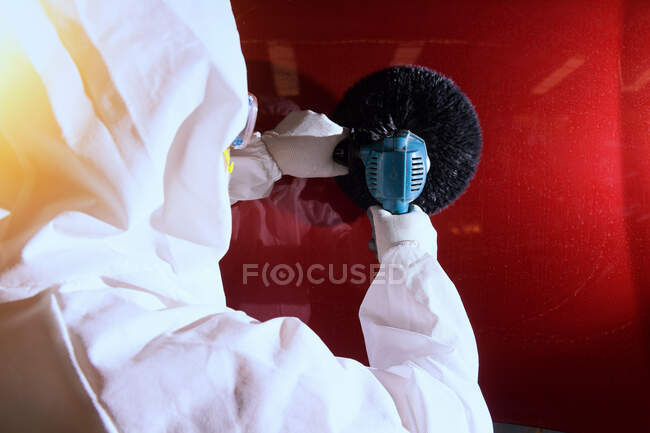 Rear view of a mechanic polishing a car, Thailand — Stock Photo