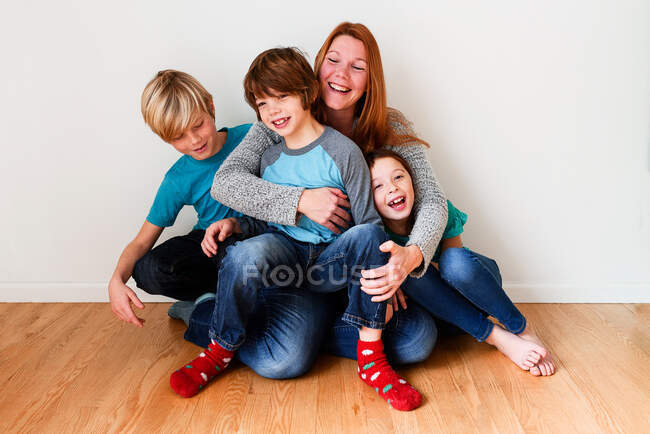 Retrato de una madre con sus tres hijos - foto de stock