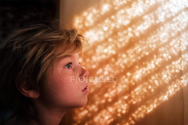 Portrait of a boy standing by a wall — Stock Photo