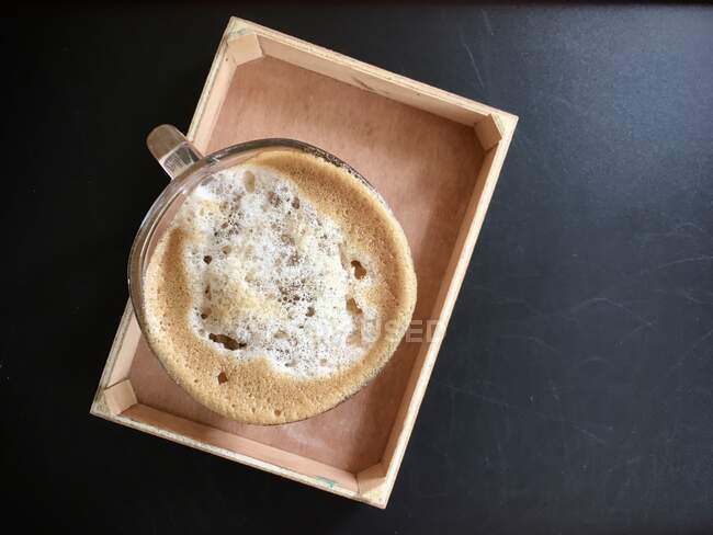 Cup of coffee on a wooden tray — Stock Photo