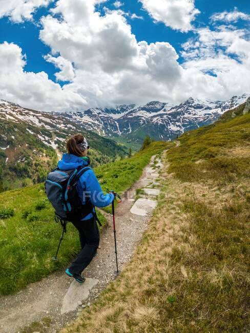 Молодая женщина ходит по тропинке в австрийских Альпах возле Гаштайна, Зальцбург, Австрия — стоковое фото