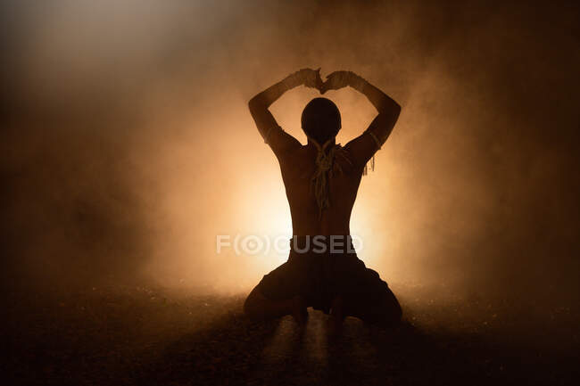Silhouette of a Thai boxer training outdoors at night, Thailand — Stock Photo