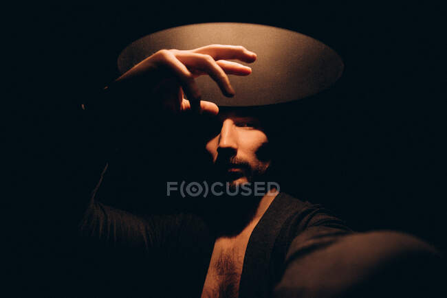 Portrait of man standing under a lamp — Stock Photo