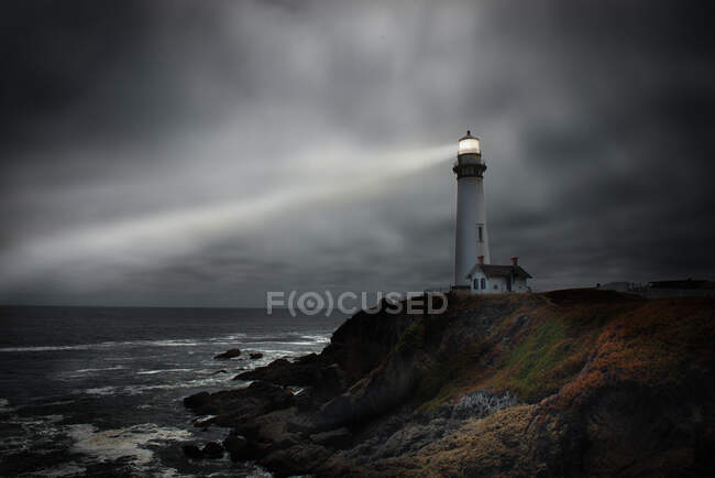 Lighthouse light beam, shining across the ocean, California, USA — Stock Photo