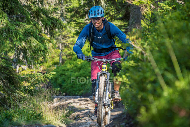 L'uomo in mountain bike lungo un sentiero nelle Alpi austriache, Saalbach, Austria — Foto stock