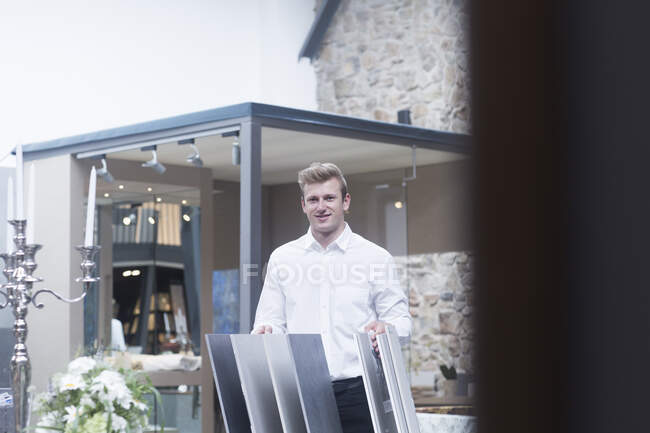 Salesman standing in a shop next to flooring samples, Germany — Stock Photo