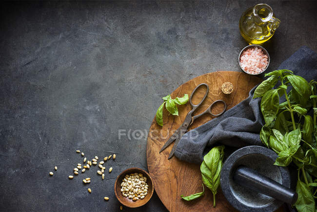 Basil, pine nuts, sea salt and olive oil ingredients to make pesto — Stock Photo