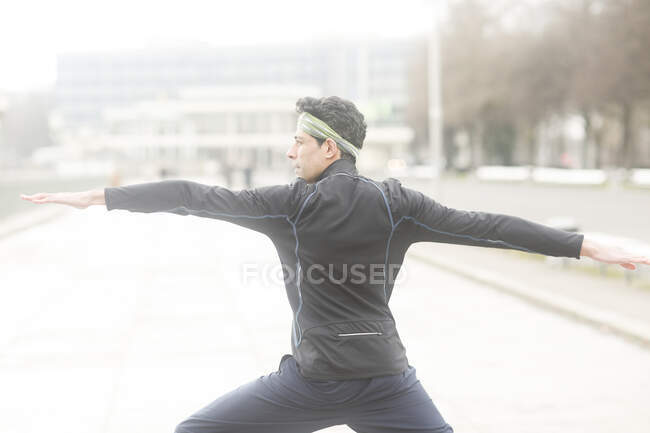 Portrait of a man standing outside doing yoga, Germany — Stock Photo