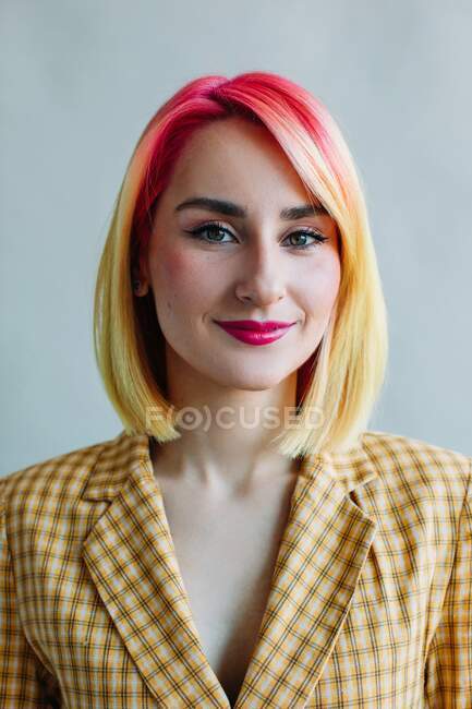 Portrait of a cool girl with dyed hair wearing a suit — Stock Photo