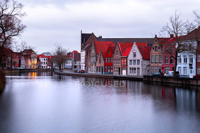 Long exposure shot of Waterfront buildings and reflections in the canal, Bruges, Belgium — Stock Photo