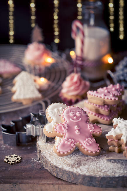 Christmas cookies, cupcakes and a bottle of milk — Stock Photo