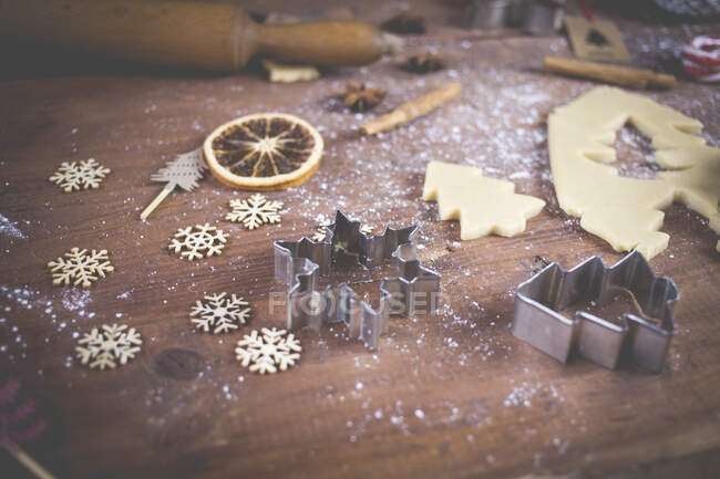 Cookie dough, cookie cutters and decorations on a wooden table — Stock Photo