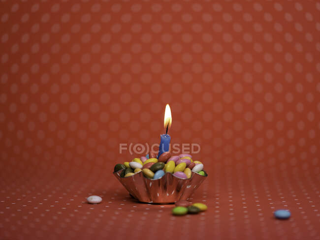 Conceptual birthday cupcake and birthday candle — Stock Photo