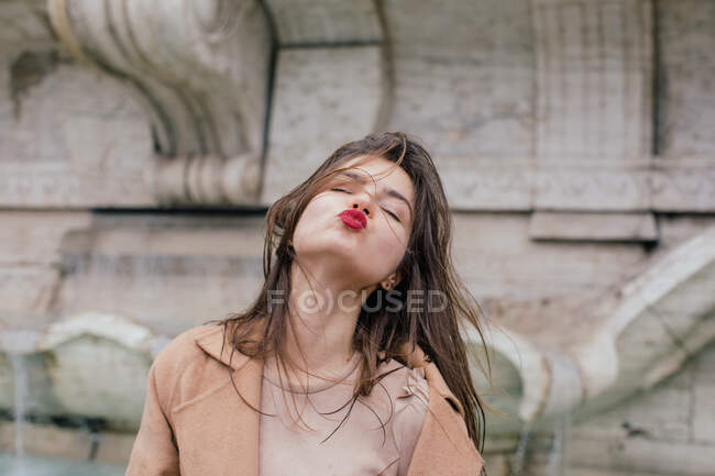 Woman puckering up and blowing a kiss, Rome, Lazio, Italy — Stock Photo