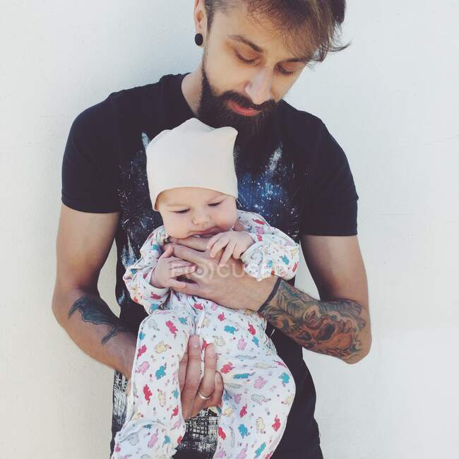 Portrait of a man holding his baby girl — Stock Photo