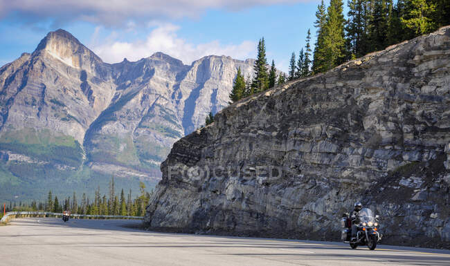 Two motorbike riders driving through the Rocky mountains, Canada — Stock Photo