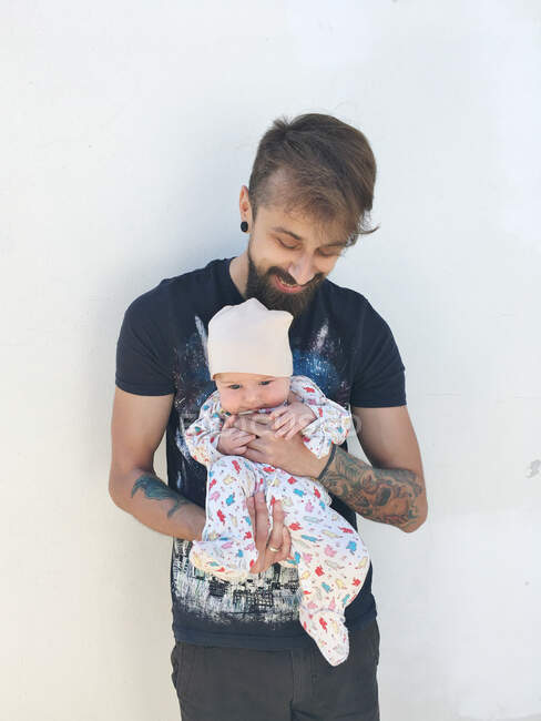 Ritratto di un uomo sorridente che tiene in braccio la sua bambina — Foto stock